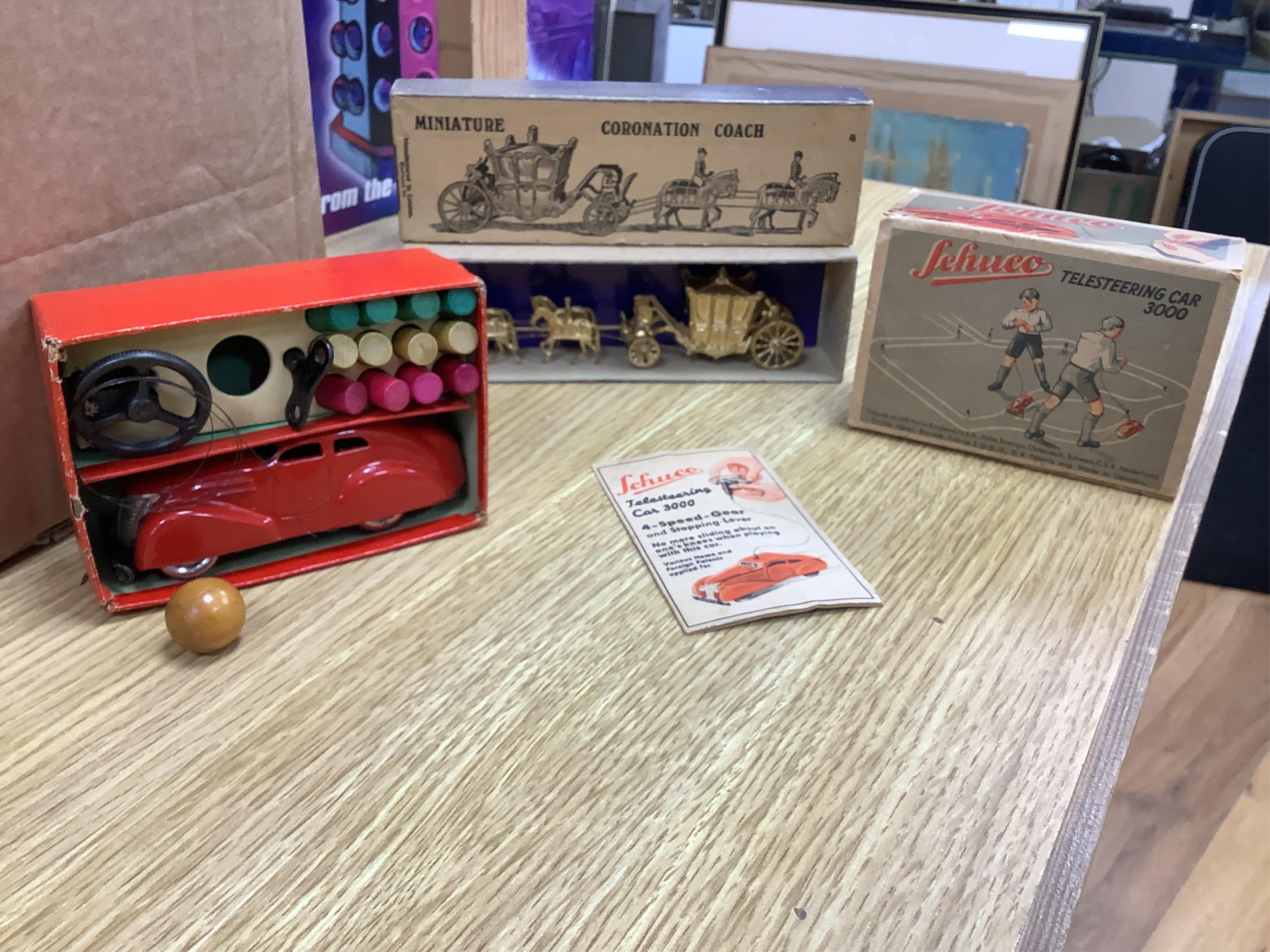 A boxed Britains Miniature Coronation Coach (1478) and a boxed Schuco Telesteering Car 3000 with accessories and instruction leaflet. Condition - good.